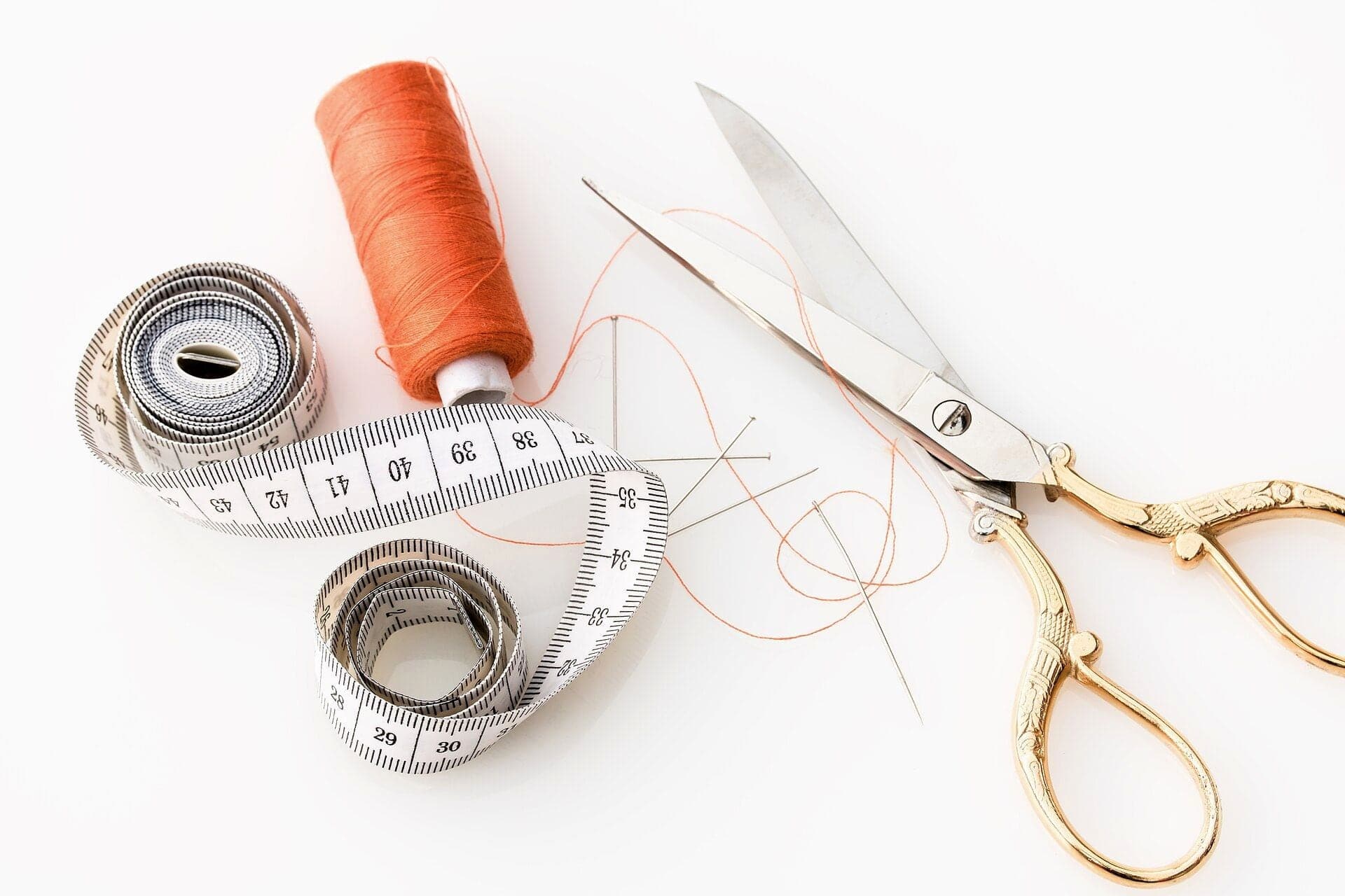 Measuring tape, thread and gold-handled scissors